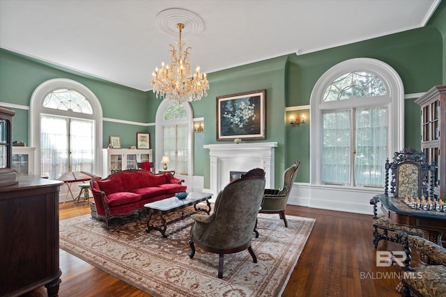 living room with french doors, a wealth of natural light, dark hardwood / wood-style flooring, and a notable chandelier