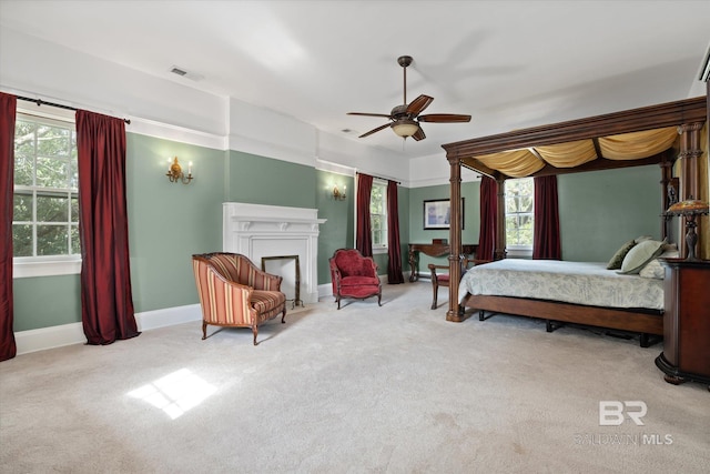 bedroom featuring ceiling fan and light carpet