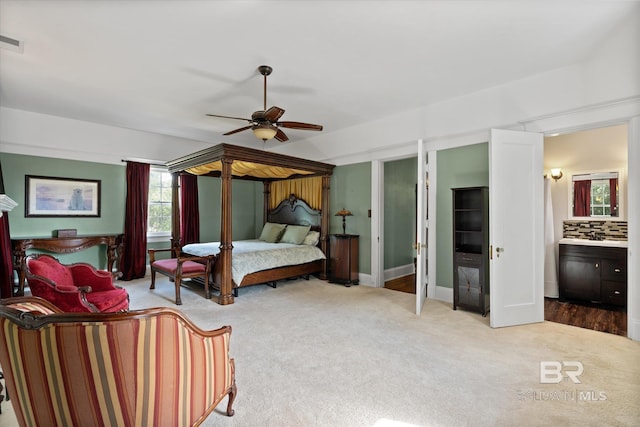 bedroom featuring ceiling fan, carpet, and ensuite bath