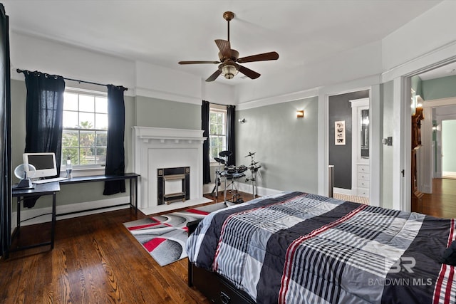 bedroom featuring multiple windows, dark wood-type flooring, and ceiling fan