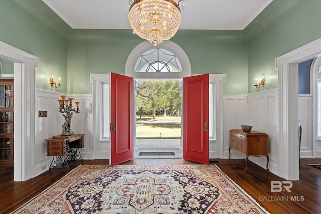 entrance foyer with an inviting chandelier and dark hardwood / wood-style floors