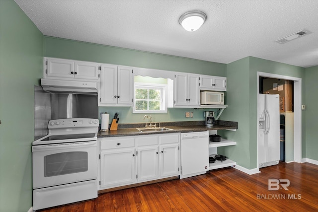 kitchen featuring sink, white appliances, and white cabinets