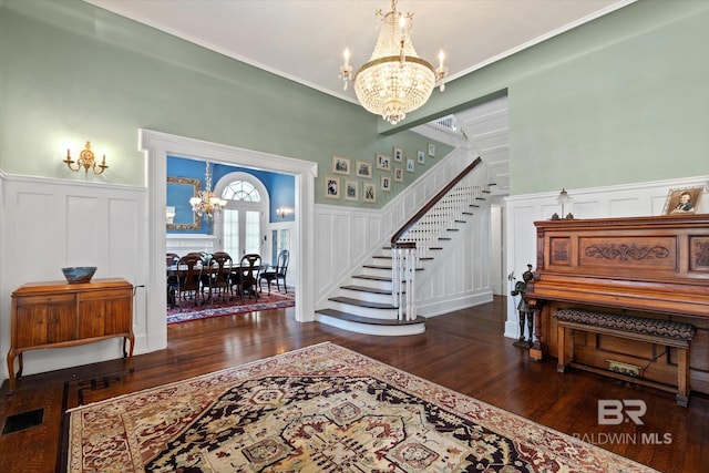 foyer with a notable chandelier and dark hardwood / wood-style flooring