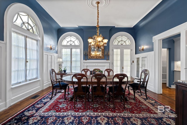 dining area featuring dark wood-type flooring, a notable chandelier, and french doors