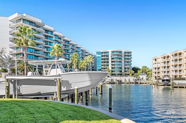 dock area with a yard and a water view