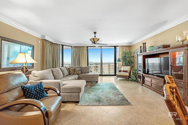 tiled living room featuring ornamental molding, expansive windows, ceiling fan, and a healthy amount of sunlight