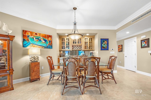 dining space with bar, light tile patterned flooring, and crown molding