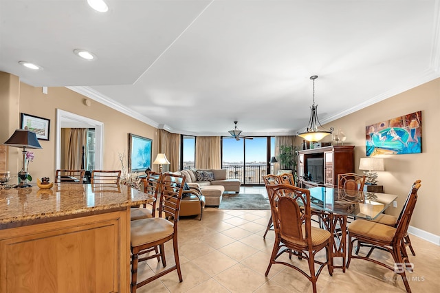 dining area with light tile patterned floors, crown molding, and ceiling fan