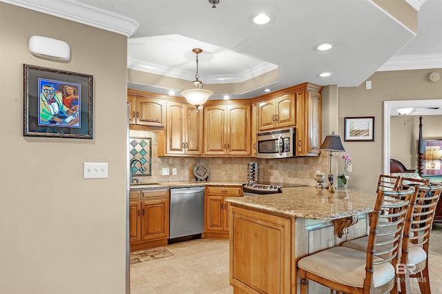 kitchen with stainless steel appliances, a kitchen bar, light tile patterned floors, pendant lighting, and kitchen peninsula