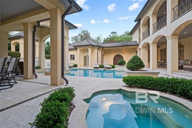 view of swimming pool featuring ceiling fan and a patio area