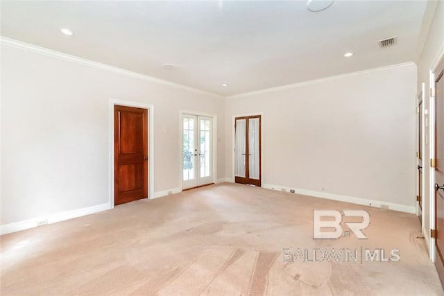 carpeted spare room with french doors and crown molding