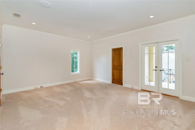 unfurnished room featuring ornamental molding, light colored carpet, and french doors