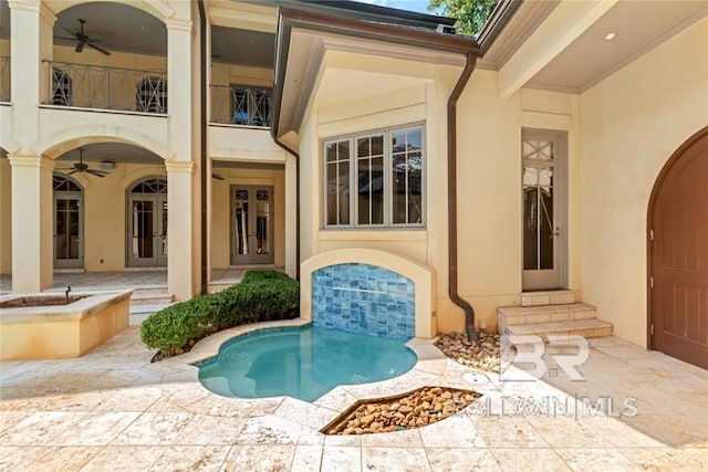 view of pool with ceiling fan and a patio area