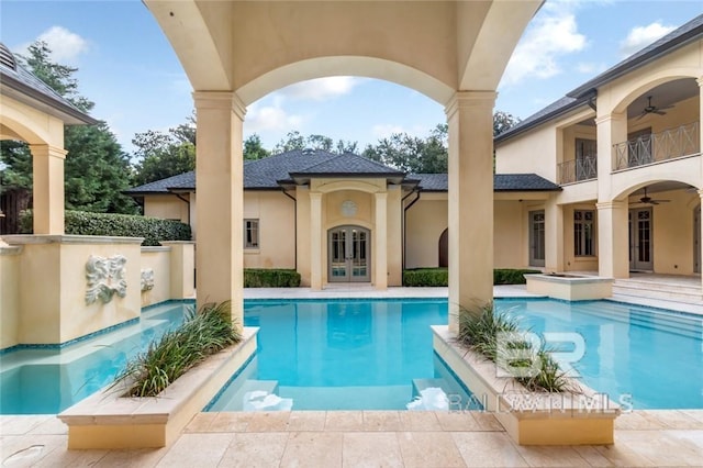 view of swimming pool featuring ceiling fan, french doors, and a patio area