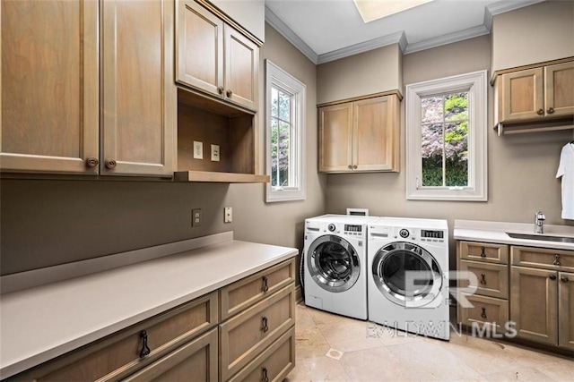 washroom featuring separate washer and dryer, ornamental molding, sink, and cabinets