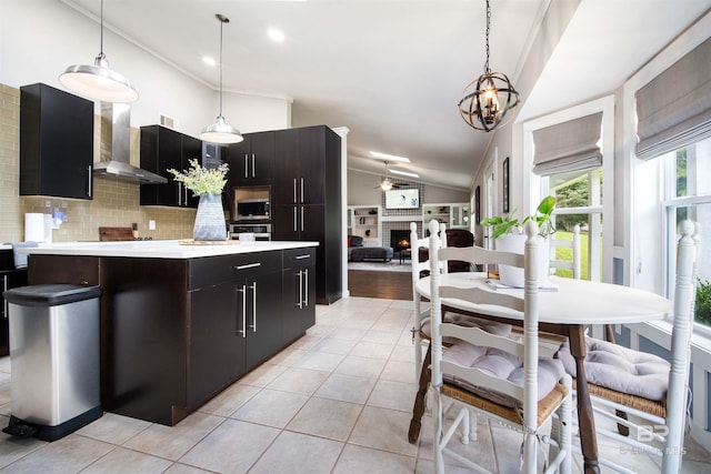 521 Parkwood Ave, Daphne, AL 36526 - kitchen featuring wall chimney exhaust hood, stainless steel appliances, vaulted ceiling, light countertops, and backsplash