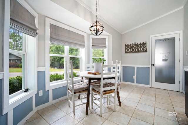 521 Parkwood Ave, Daphne, AL 36526 - dining room featuring lofted ceiling, ornamental molding, plenty of natural light, light tile patterned flooring, and a chandelier