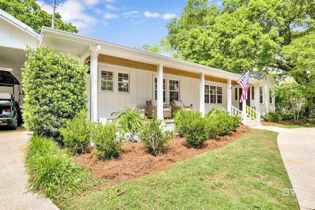 view of front of home with a porch, a carport, and board and batten siding