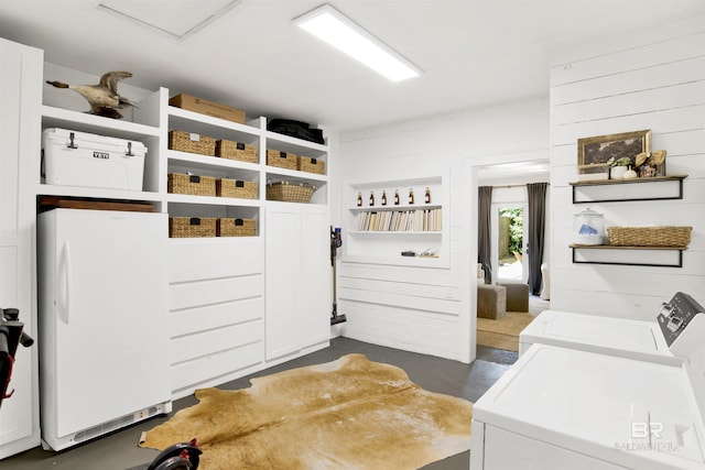 mudroom featuring concrete flooring and independent washer and dryer
