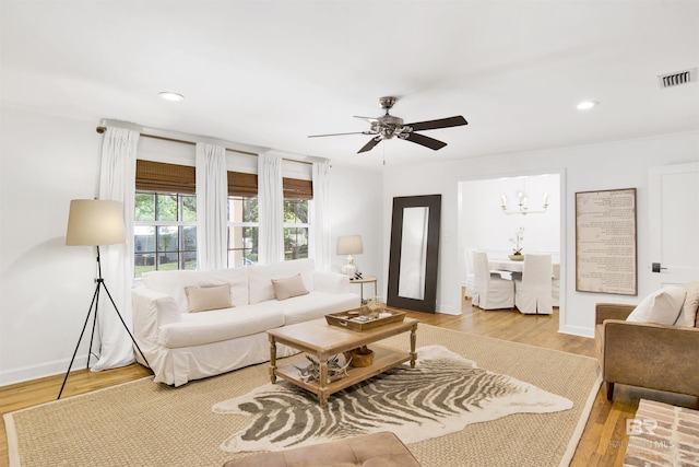 living area featuring wood finished floors, visible vents, a ceiling fan, and recessed lighting
