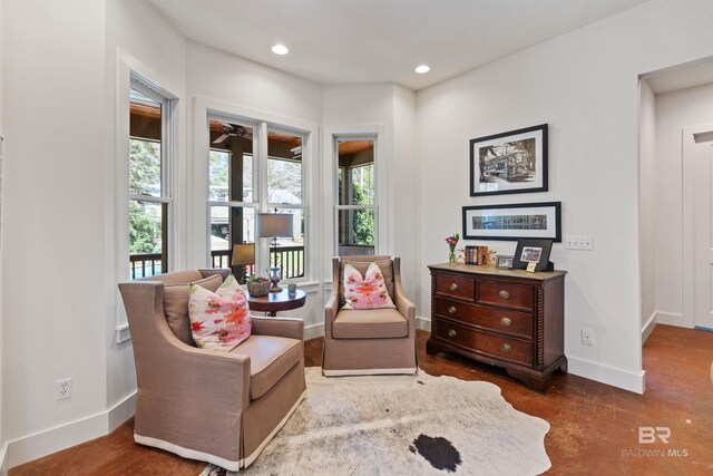 living area with recessed lighting, baseboards, and ceiling fan