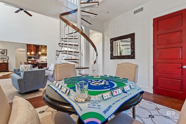 dining room with visible vents, stairs, and ceiling fan