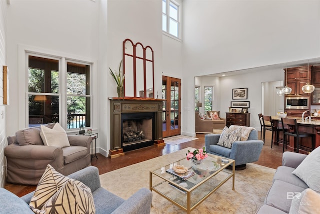 living room featuring a fireplace and baseboards