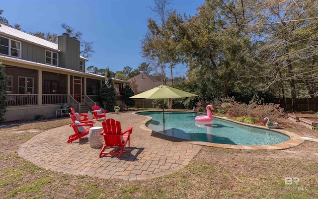 pool with a patio and a sunroom