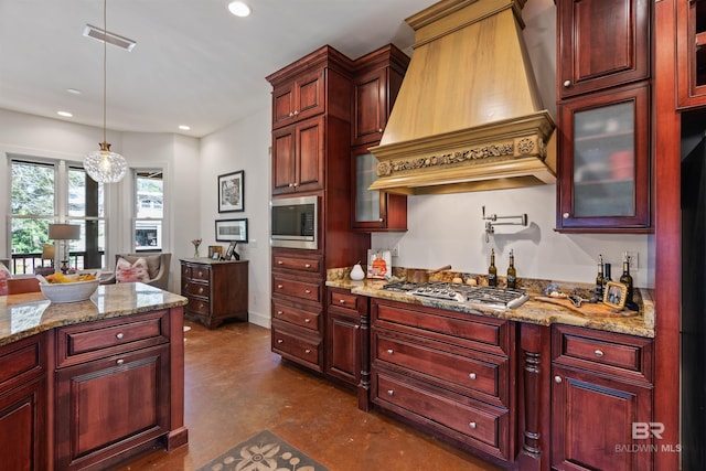 kitchen featuring custom exhaust hood, dark brown cabinets, and stainless steel appliances