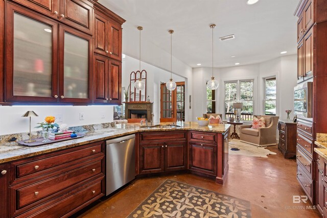 kitchen with visible vents, a peninsula, a sink, hanging light fixtures, and dishwasher