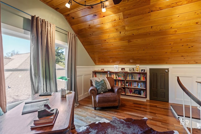 sitting room with a wainscoted wall, wood finished floors, a decorative wall, wood ceiling, and vaulted ceiling