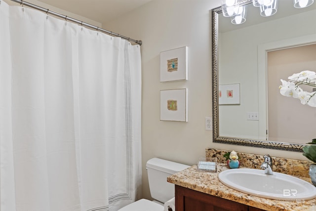 bathroom featuring a shower with shower curtain, toilet, and vanity