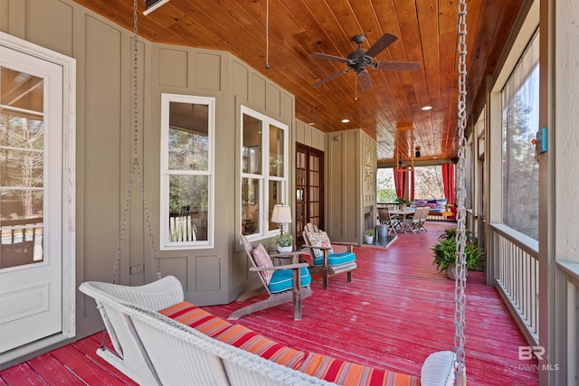 sunroom / solarium featuring wood ceiling and ceiling fan