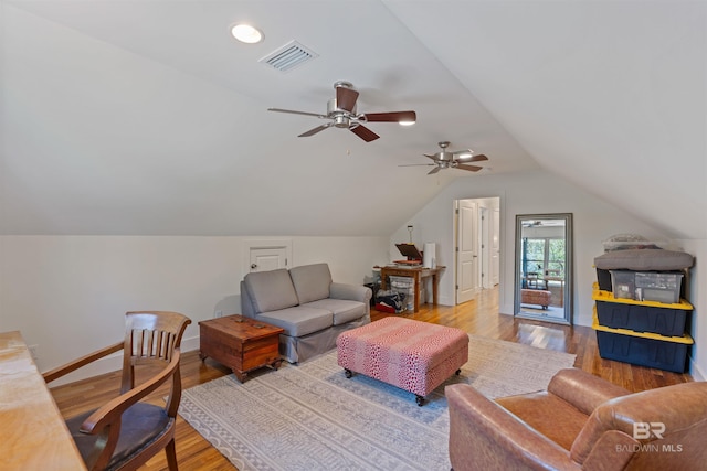 interior space featuring visible vents, baseboards, vaulted ceiling, recessed lighting, and wood finished floors