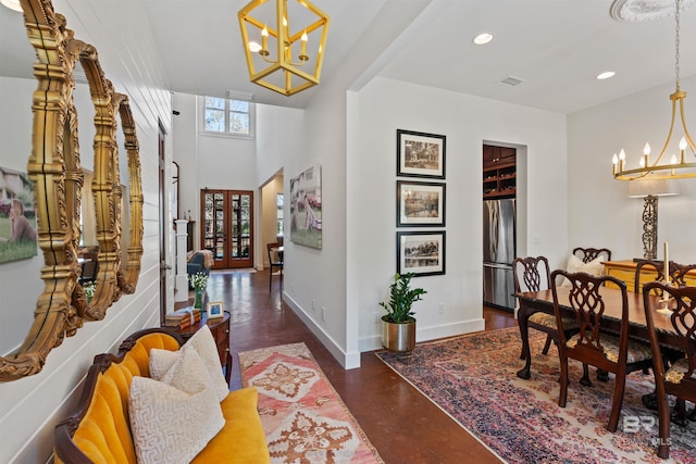 dining room featuring visible vents, finished concrete flooring, baseboards, recessed lighting, and a notable chandelier