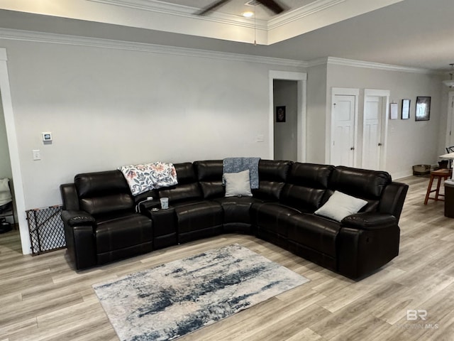 living area featuring coffered ceiling, ornamental molding, and light wood-type flooring
