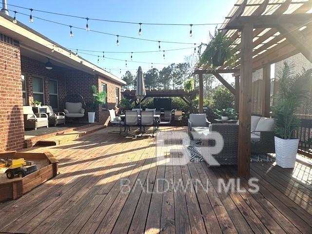 deck with an outdoor living space, a pergola, and outdoor dining area