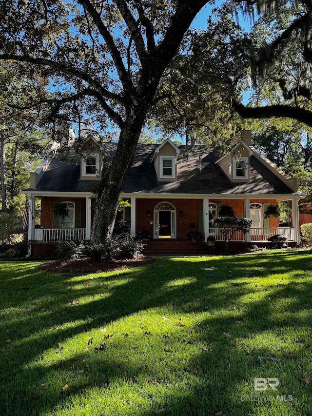 view of front of house featuring a front yard and covered porch