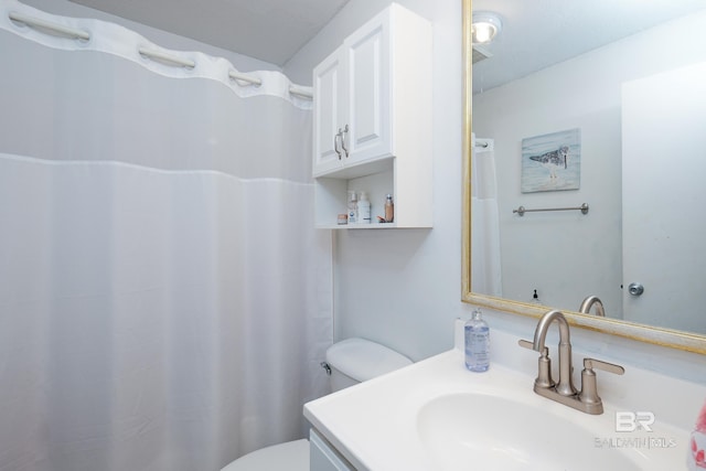 bathroom featuring vanity and toilet