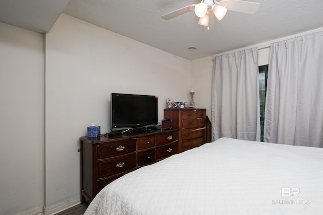 bedroom with a textured ceiling and ceiling fan