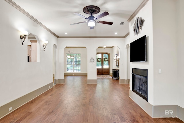 unfurnished living room with ornamental molding, ceiling fan, and hardwood / wood-style floors