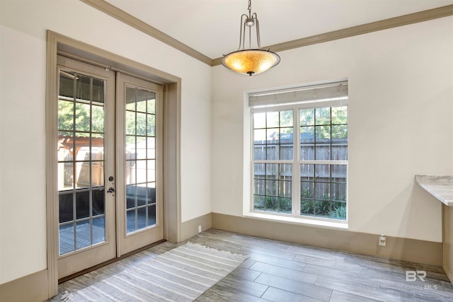 entryway with french doors, hardwood / wood-style floors, and crown molding