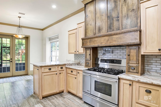 kitchen with pendant lighting, range with two ovens, kitchen peninsula, and backsplash