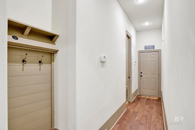 corridor with wood-type flooring