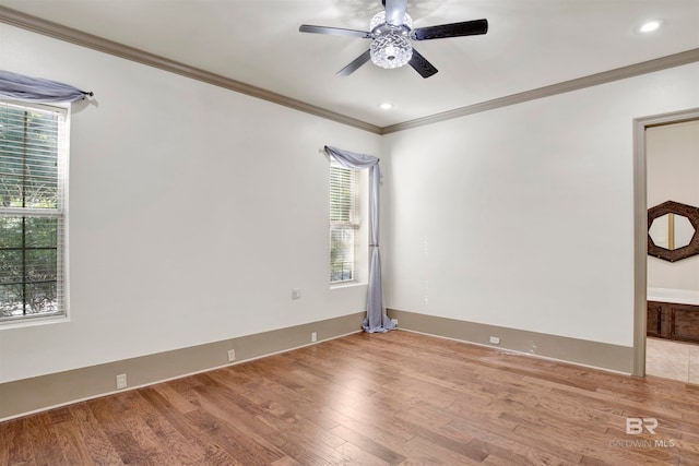 empty room featuring ornamental molding, hardwood / wood-style flooring, and ceiling fan