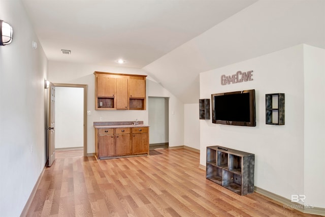 unfurnished living room with lofted ceiling and light hardwood / wood-style floors