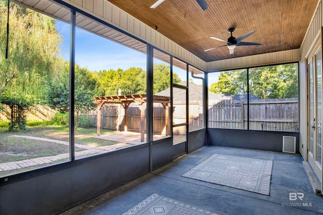 unfurnished sunroom featuring wooden ceiling and ceiling fan