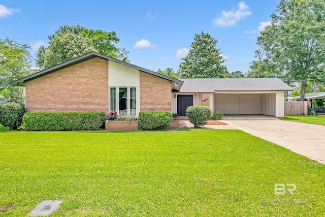 18 Rollins Pl, Atmore, AL 36502 - mid-century inspired home featuring brick siding, concrete driveway, and a carport