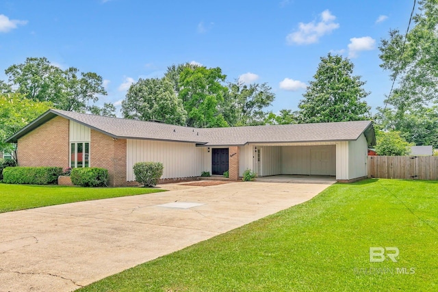 18 Rollins Pl, Atmore, AL 36502 - mid-century modern home with driveway, a shingled roof, and brick siding