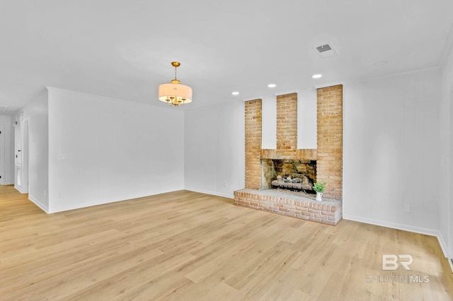 18 Rollins Pl, Atmore, AL 36502 - unfurnished living room with light wood-type flooring, recessed lighting, and a fireplace